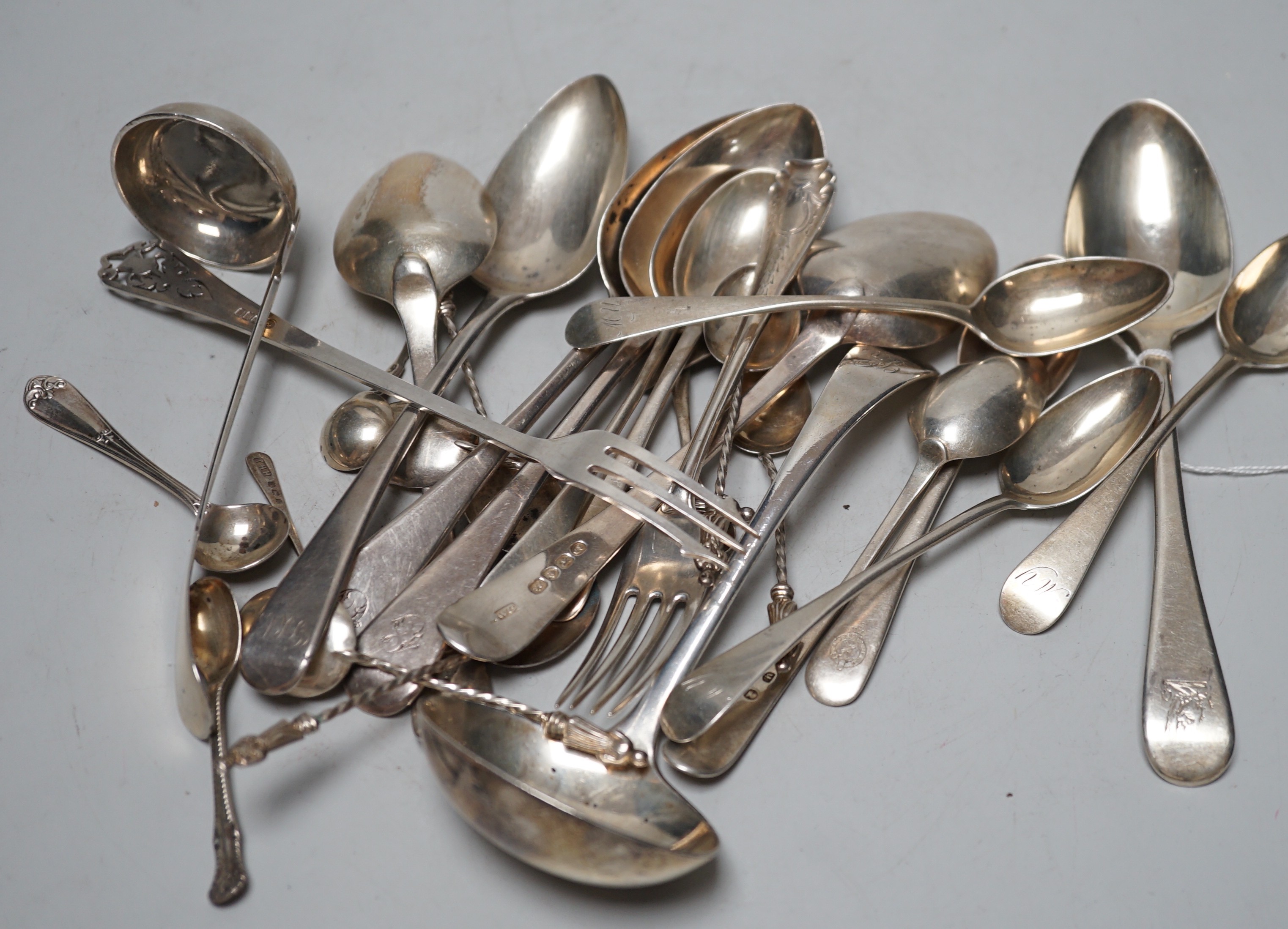 Assorted 19th century and later silver flatware, including dessert spoons, coffee spoons, two ladles, pickle forks, etc. various date and makers, 18.8oz.